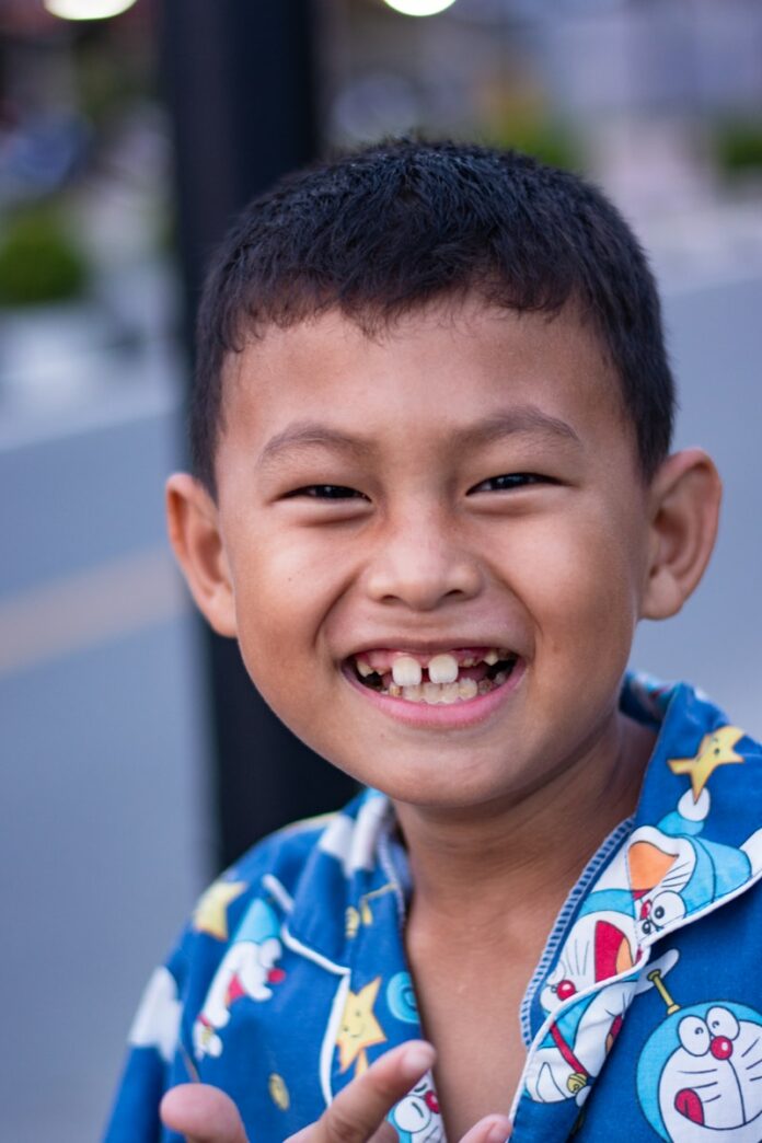 Photo by Reynardo Etenia Wongso boy in blue and yellow crew neck shirt smiling