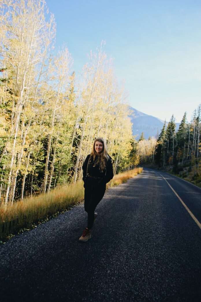 Photo by Giorgio Trovato woman in black jacket standing on road during daytime