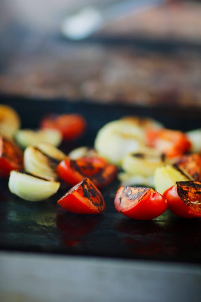 Photo by alaa turkman a close up of sliced vegetables on a grill