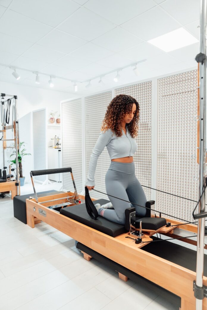 Photo by Ahmet Kurt a woman on a treadmill in a gym