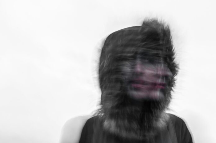 Photo by Ehimetalor Akhere Unuabona Creepy blurred photo of a person's face and a furry hood